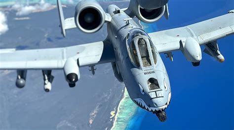 A-10 Warthog landing at forward operating base with dust clouds rising around it