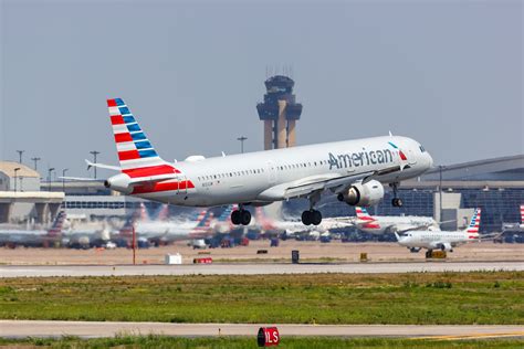 a321xlr parked at DFW airport runway during sunrise before international long-haul service