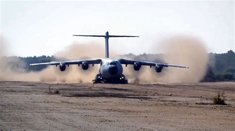 A400M taxiing on short unpaved runway during firefighting training in Mediterranean region