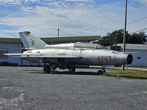 abandoned MiG-21 fighter jets parked desert airbase rusting