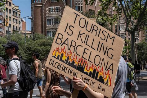 activists in Venice blocking canal ferry terminal with signs about overtourism impact