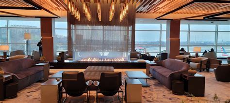Admirals Club Denver lounge with fireplace and panoramic window view