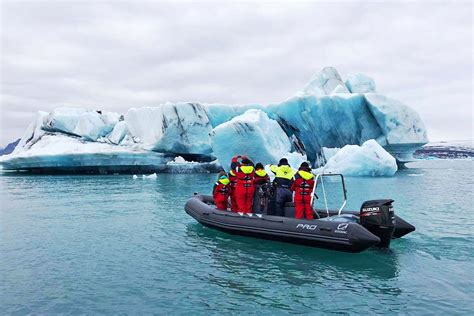 aerial shot of Antarctic cruise passengers exploring icebergs via Zodiac boats