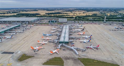 Aerial view of London Stansted Airport capturing passenger terminals and solar installations under MAG’s green infrastructure push