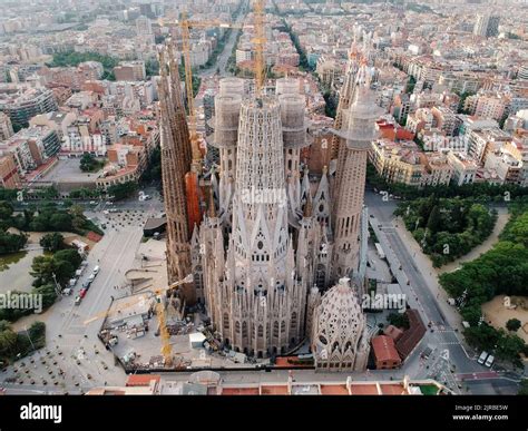 Aerial view of Sagrada Família under the summer sun with tourists around