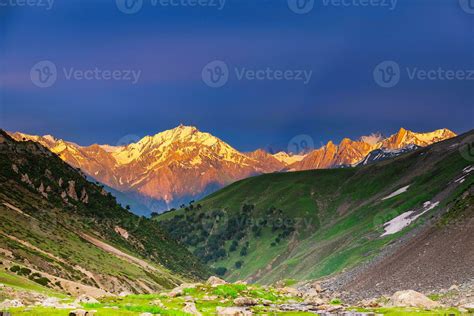 aerial view of Sonmarg valley in golden hour light, with winding rivers and snow-capped peaks