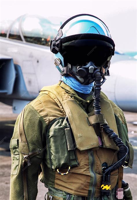 Aerobatic pilot in cockpit wearing g-suit and oxygen mask mid-competition flight
