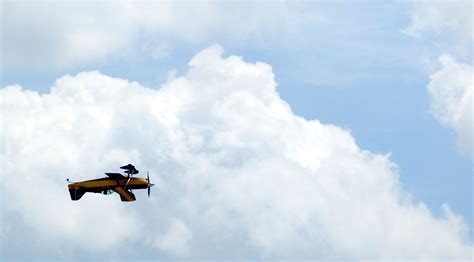 aerobatic plane flying upside down in a blue sky