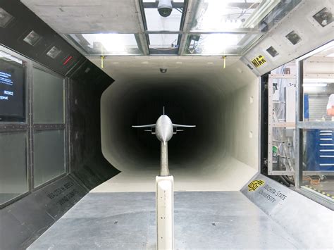 aeronautical engineer analyzing wind tunnel data with aircraft model