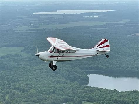aeronca champ with extended gear at rural airstrip