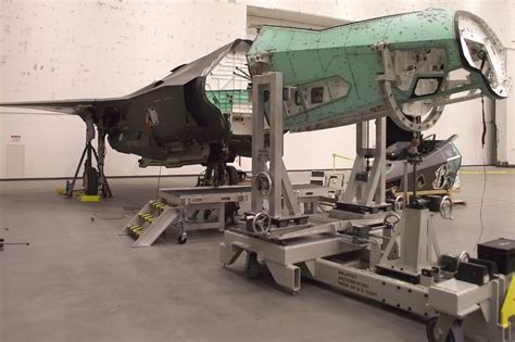 aerospace engineers working on composite airframe section for next-gen jetliner