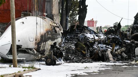 Aftermath of Challenger 300 crash near Buenos Aires showing wreckage in residential area