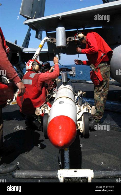 AGM-88 HARM missile mounted on an F/A-18E during pre-flight inspection