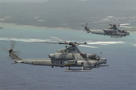 AH-1Z Viper attack helicopter flying alongside an F-35B Lightning II during Marine Corps operations