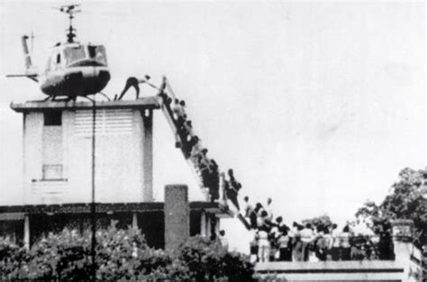 air america helicopter evacuating civilians from saigon rooftop april 1975