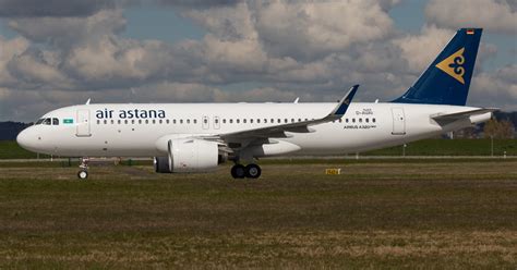 Air Astana Airbus A320neo taxiing on runway with airline livery