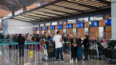 air astana check-in counters at istanbul airport with passengers waiting