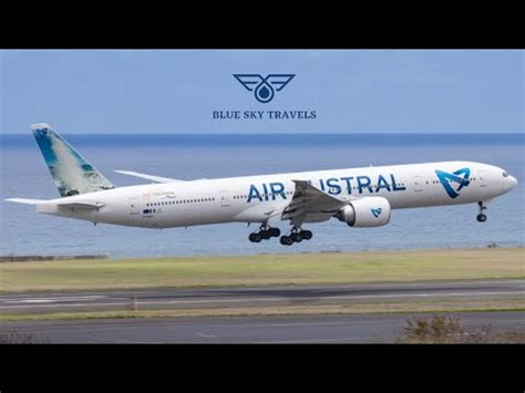 air austral boeing 777-300ER taxiing in mauritius with lush mountains in background