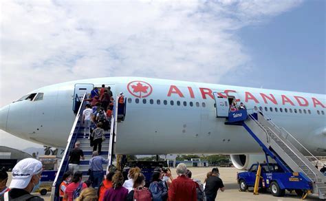Air Canada boarding gate with passengers en route to new Mexico destinations