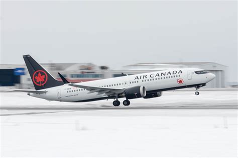 Air Canada Boeing 737 MAX 8 lifting off from Toronto’s runway 23 with downtown skyline in background