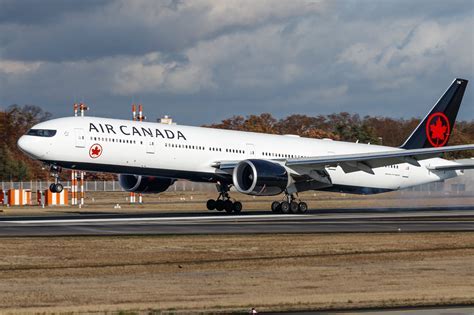 air canada flight crew walking through winter terminal with latin american signage