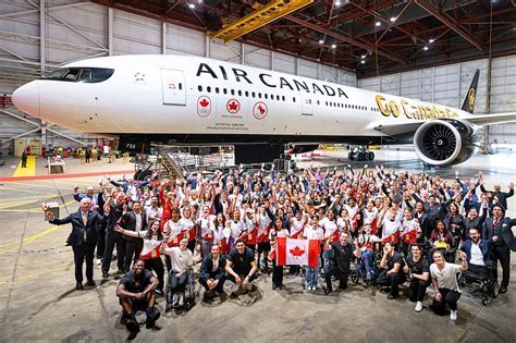 air canada staff loading luggage on tarmac with snow-capped background in yukon
