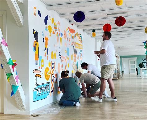 Air Canada Vacations team painting a mural with Jamaican students at community outreach event