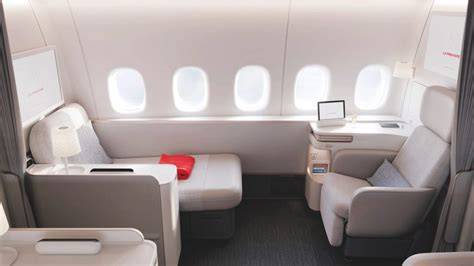 Air France’s redesigned La Première first-class suite aboard the Boeing 777-300ER with a separate chaise lounge, convertible bed, five windows, and floor-to-ceiling privacy curtain