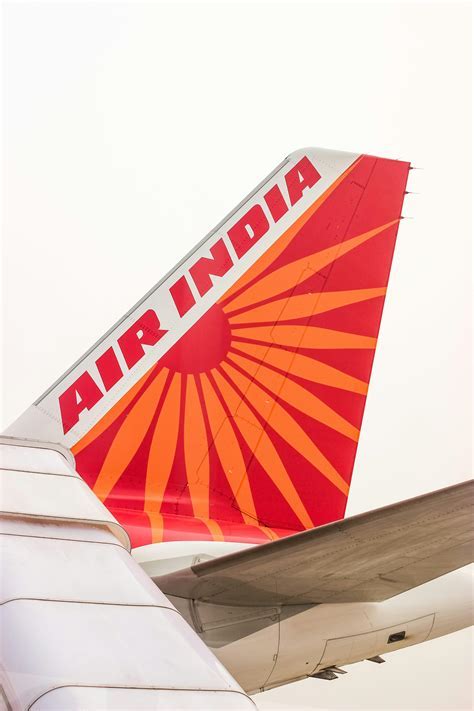 air india tail fin at heathrow with london skyline in background