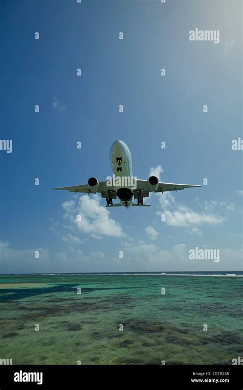Air New Zealand aircraft at Rarotonga Airport with Pacific landscape