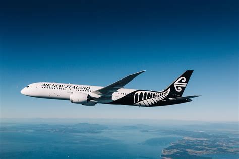 air new zealand aircraft in flight towards sydney skyline