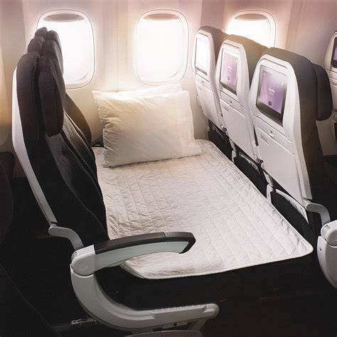 Air New Zealand Economy Skycouch with three economy seats transformed into a shared resting area with mattress padding and pillows