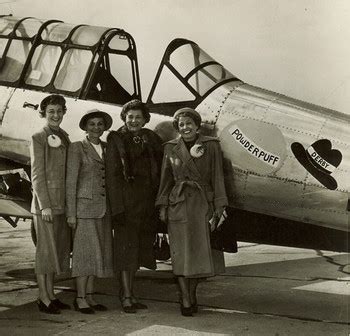 air race classic female pilots at finish line with vintage aircraft