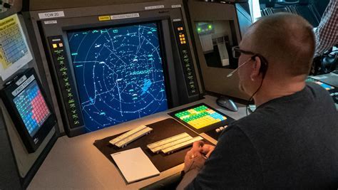 Air traffic controller at TRACON station monitoring radar and managing VFR traffic