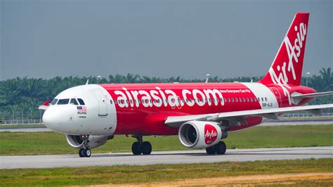 AirAsia A320 aircraft in its signature red livery on the tarmac