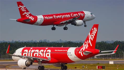 airasia airbus a320 taxiing with haiphong skyline in background