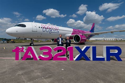 airasia airbus a321xlr at airport with boarding bridge attached