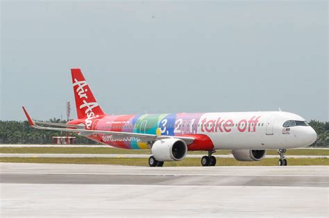 AirAsia aircraft on tarmac with MOVE branding visible on mobile screen