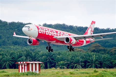 airasia aircraft touching down at jenderal ahmad yani international airport semarang