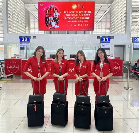 airasia ground staff celebrating new route at darwin international airport