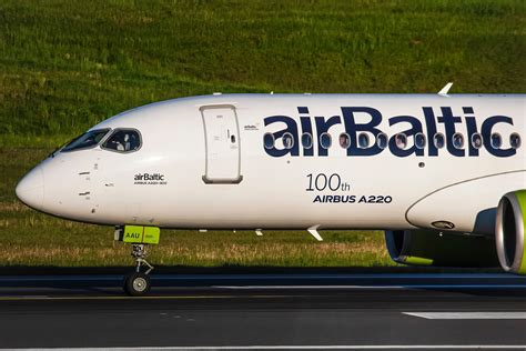 airBaltic Airbus A220 taxiing at Riga International Airport under winter skies