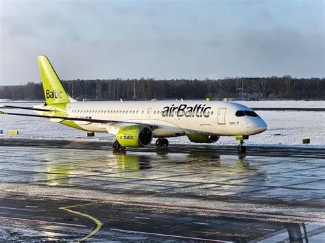 airBaltic flight preparing for takeoff with fuel price concerns illustrated by financial overlay