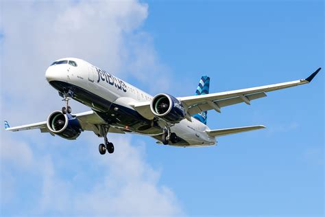 Airbus A220-300 in airline livery during delivery flight