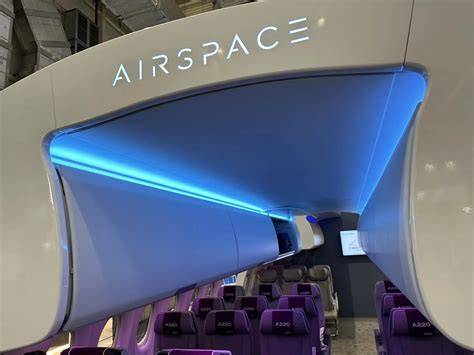 Airbus A220 Airspace cabin interior with large windows and LED lighting