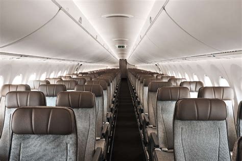 Airbus A220 cabin interior showing high ceiling and wide aisle