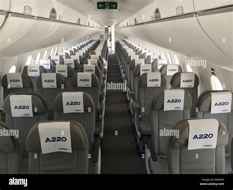 Airbus A220 cabin window view during transcontinental flight over mountains