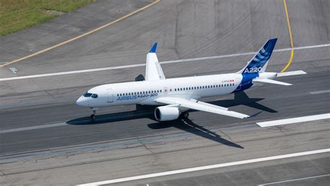 Airbus A220 parked at gate showcasing modern regional jet design