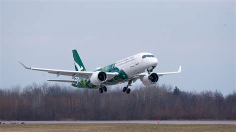 airbus a220 taking off from mirabel plant with cloudy skies overhead