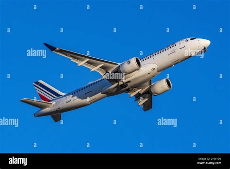 Airbus A220 taking off on transcontinental route at sunset