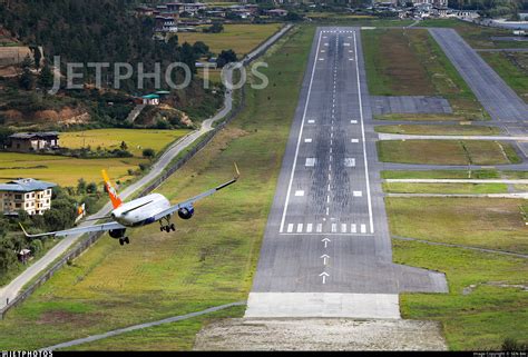 Airbus A319 maneuvering through Himalayan valley toward Paro International Airport